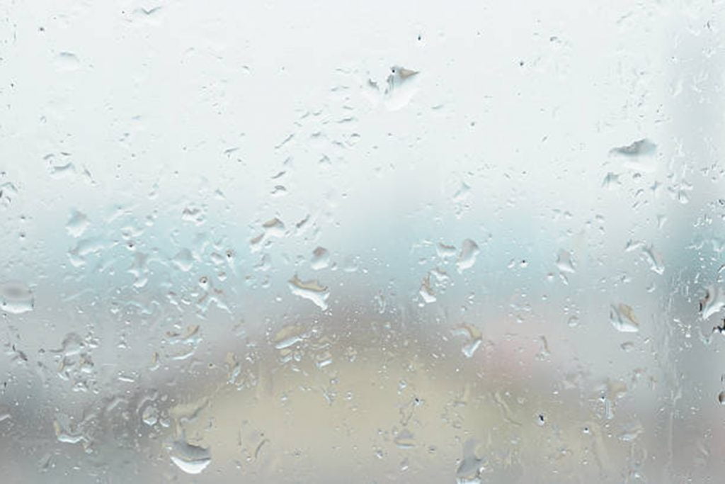Window glass with water vapor and raindrop during a rainstorm.